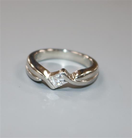 A platinum and solitaire princess cut diamond ring, size I/J.